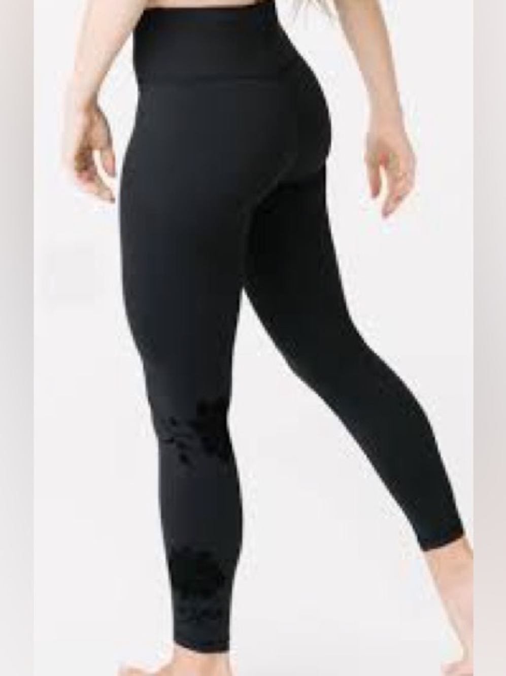 Zyia Active leggings featuring a floral appliqué detail near the ankle. Size 4.
